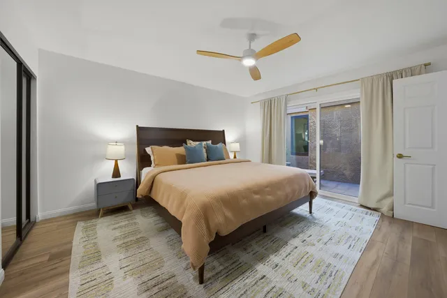 a bedroom with a large bed and a chandelier