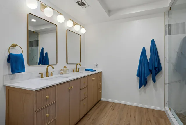 a bathroom with a sink vanity and a mirror