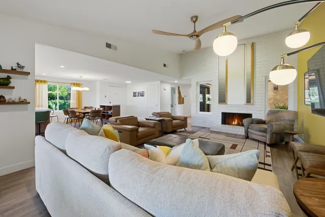 a living room with furniture and a mirror