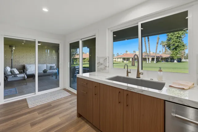 a kitchen with a sink and large window