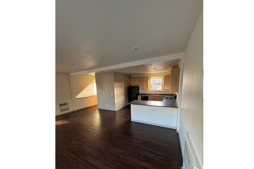 3386 Sharatin Road Other, AK 99615 - Photo 4 of 9 a view of a living room with kitchen and wooden floor