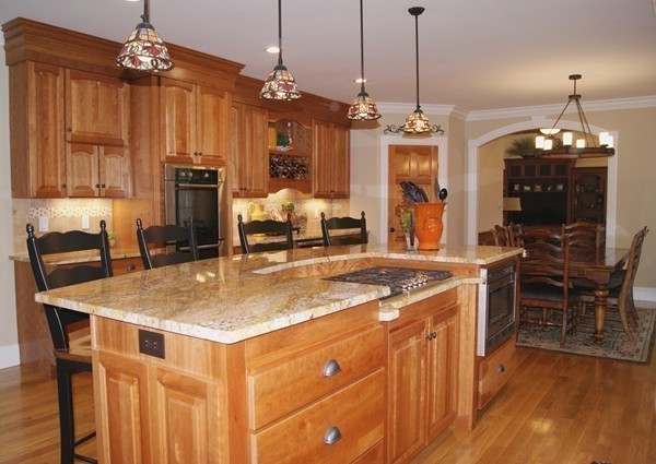 26 Cider Circle Bolton, MA 01740 - Photo 13 of 30 a kitchen with a counter a refrigerator and a wooden cabinets