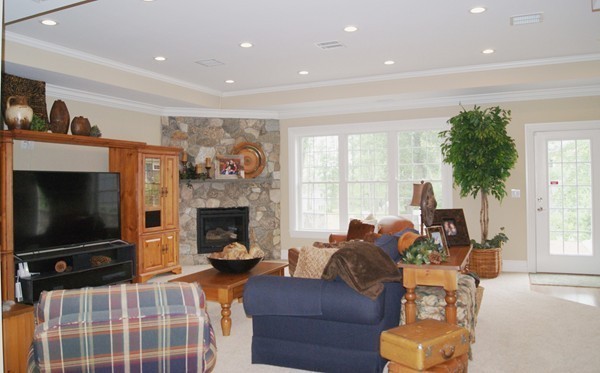 26 Cider Circle Bolton, MA 01740 - Photo 17 of 30 a living room with furniture a flat screen tv and a fireplace