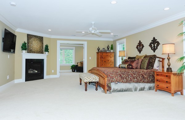 26 Cider Circle Bolton, MA 01740 - Photo 20 of 30 a spacious bedroom with a bed and a fireplace