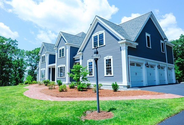 26 Cider Circle Bolton, MA 01740 - Photo 2 of 30 a front view of a house with a yard and garage