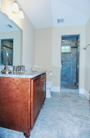 26 Cider Circle Bolton, MA 01740 - Photo 27 of 30 a bathroom with a granite countertop sink a mirror and a shower