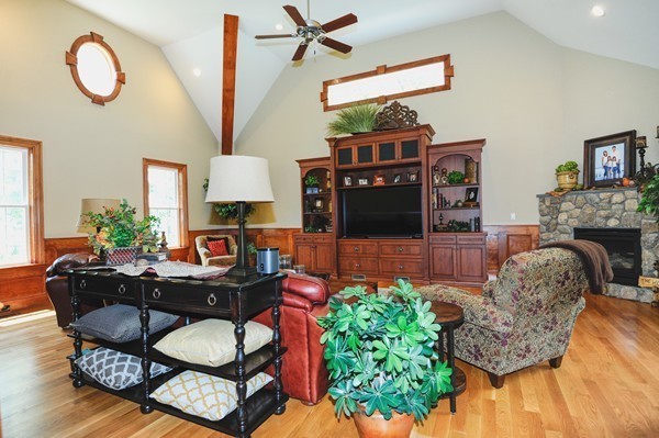 26 Cider Circle Bolton, MA 01740 - Photo 9 of 30 a living room with furniture a fireplace and a potted plant