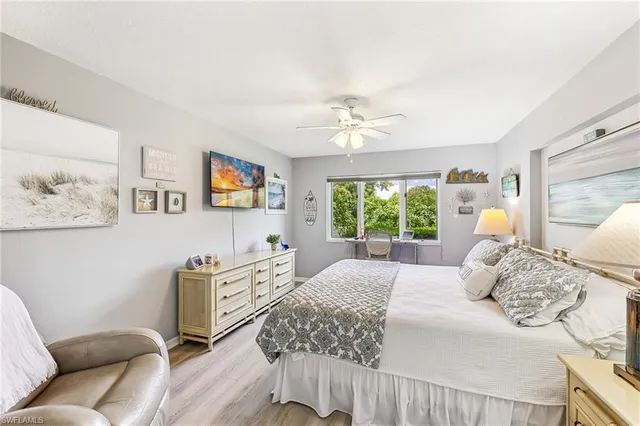 a bedroom with a bed a couch and window