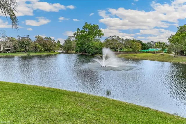 a view of a lake with houses in the back
