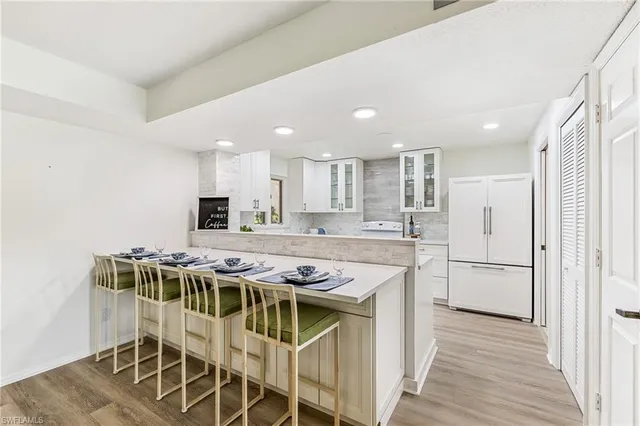 a kitchen with a table chairs stove and cabinets