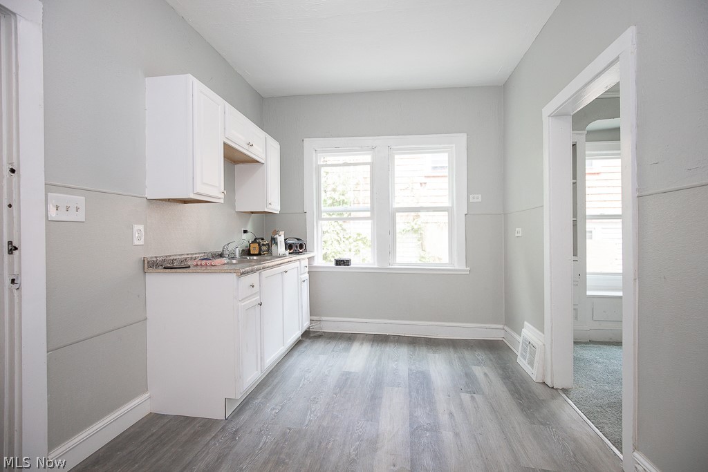 1000 Eddy Road Cleveland, OH 44108 - Photo 11 of 38 Kitchen with white cabinetry, light countertops, and light wood-style flooring
