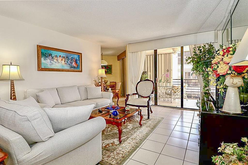 a living room with furniture and flowers