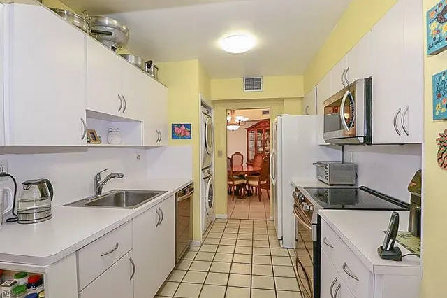 a kitchen with a sink appliances and cabinets