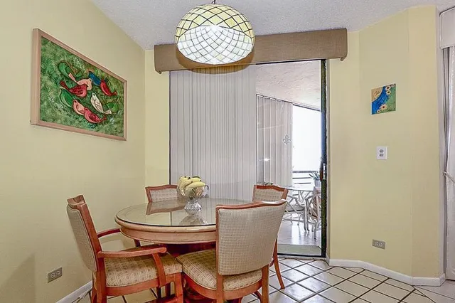 a view of a dining room with furniture and a window