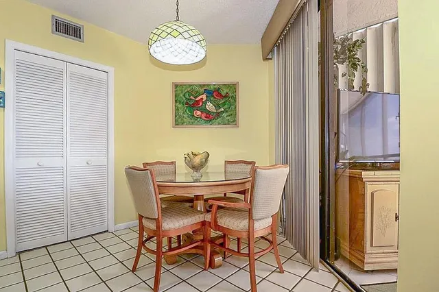 a view of a dining room with furniture and a window