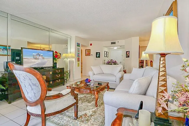 a living room with furniture and a lamp