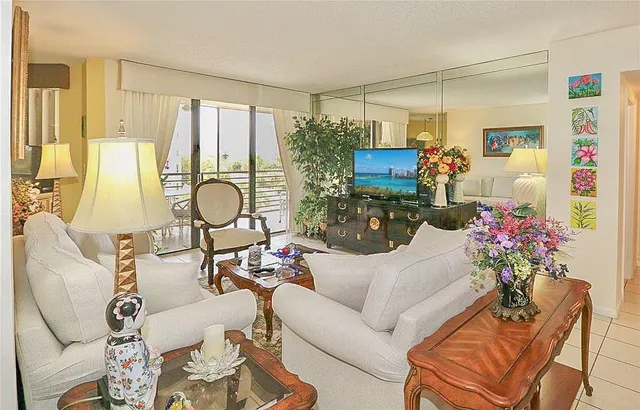 a living room with furniture and flowers