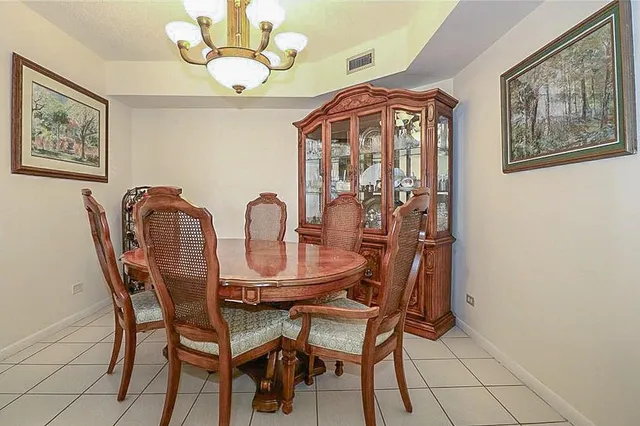 a view of a dining room with furniture and chandelier