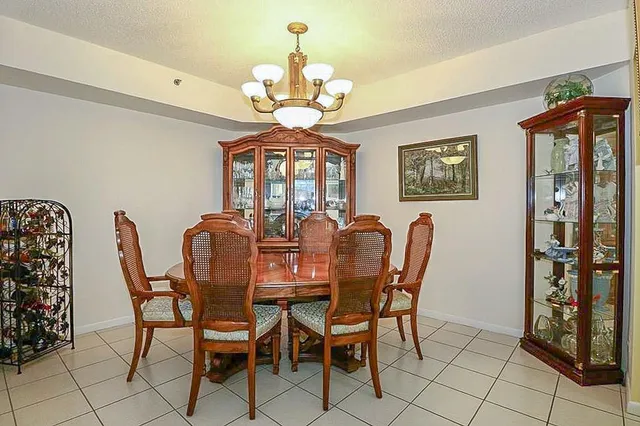 a view of a dining room with furniture and chandelier