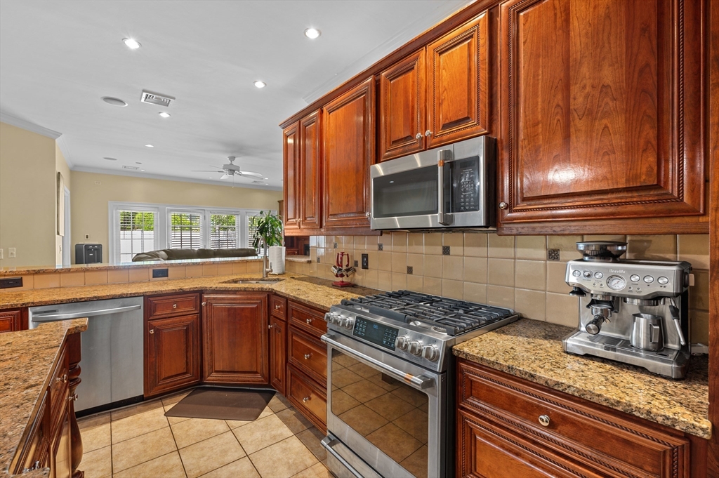 2 Herbert Road Worcester, MA 01602 - Photo 12 of 33 a kitchen with stainless steel appliances granite countertop wooden cabinets stove top oven and sink