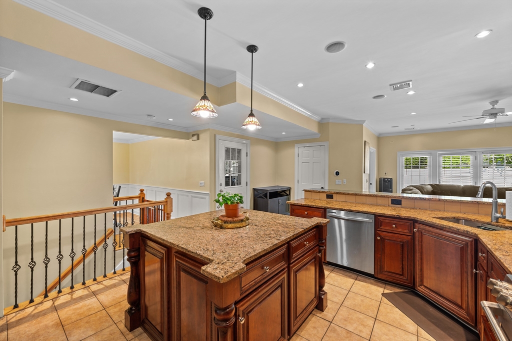 2 Herbert Road Worcester, MA 01602 - Photo 15 of 33 a kitchen with a stove a sink dishwasher with a dining table and chairs with wooden floor