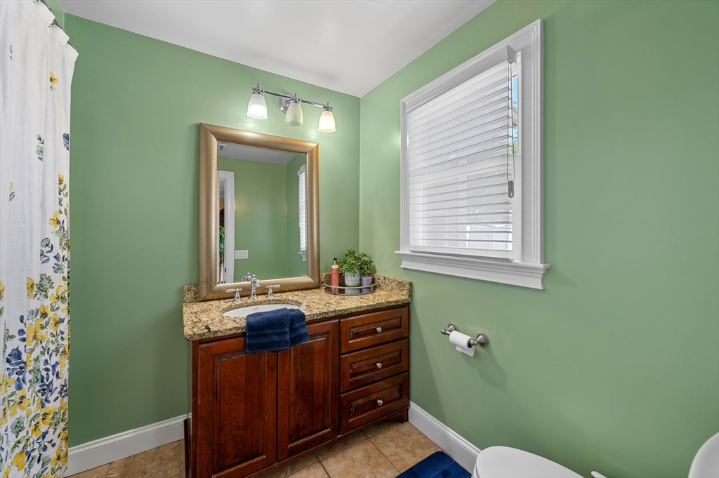 2 Herbert Road Worcester, MA 01602 - Photo 18 of 33 a bathroom with a mirror a sink and a toilet