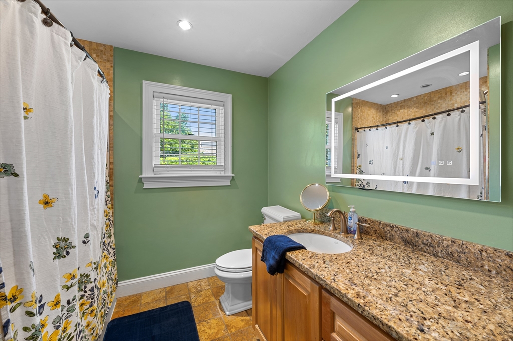 2 Herbert Road Worcester, MA 01602 - Photo 22 of 33 a bathroom with a granite countertop sink a toilet and mirror