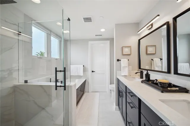 a bedroom with a large bed and a flat tv screen