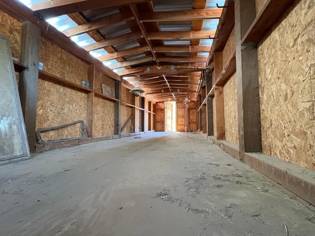 a kitchen with stainless steel appliances granite countertop a sink refrigerator and cabinets