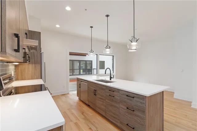 a large kitchen with kitchen island a sink stainless steel appliances and a counter top