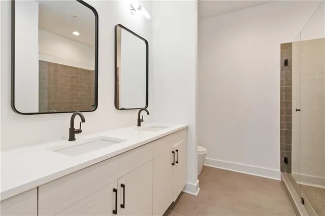 a bathroom with a double vanity sink and mirror