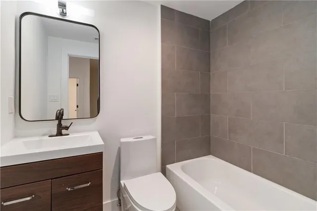 a bathroom with a sink a toilet and mirror