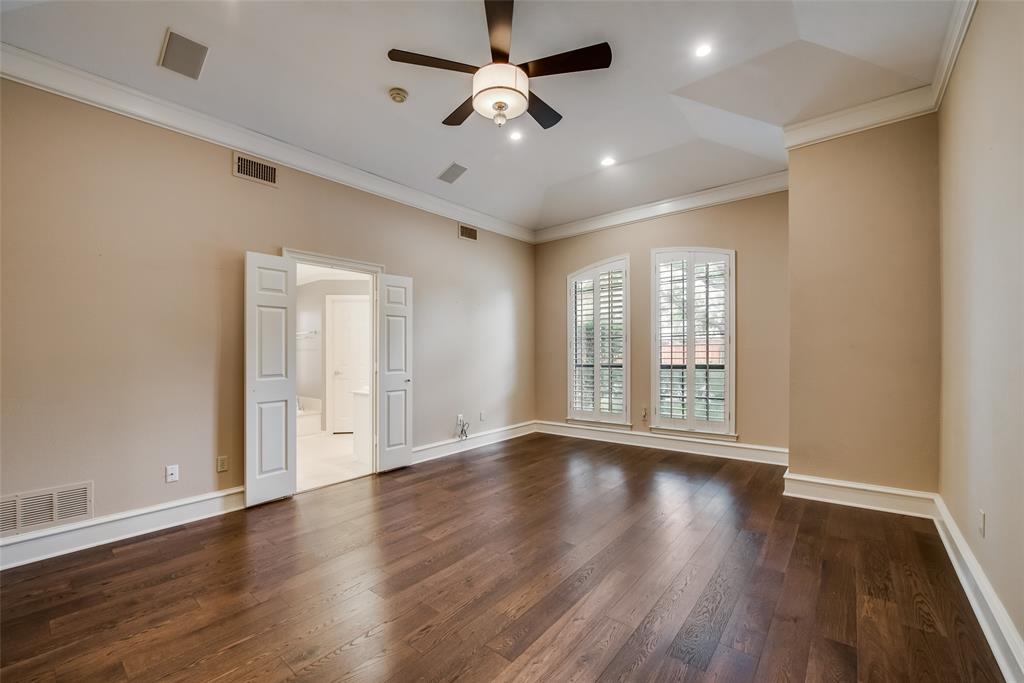 15720 Golden Creek Road Dallas, TX 75248 - Photo 15 of 25 This room features rich hardwood flooring, a ceiling fan with integrated lighting, recessed lighting, and two arched windows with plantation shutters