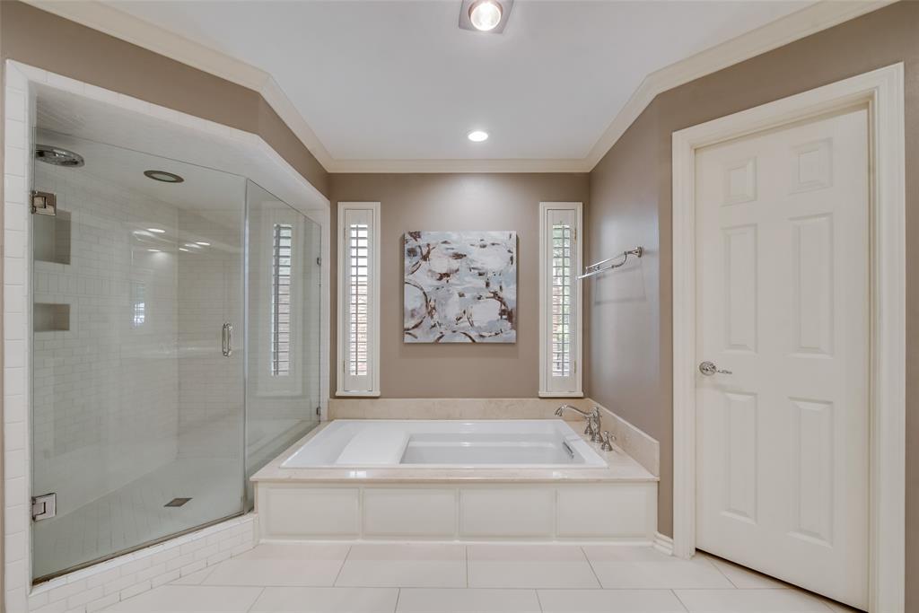 15720 Golden Creek Road Dallas, TX 75248 - Photo 16 of 25 The bathroom features a spacious glass-enclosed shower, a built-in bathtub, and recessed lighting