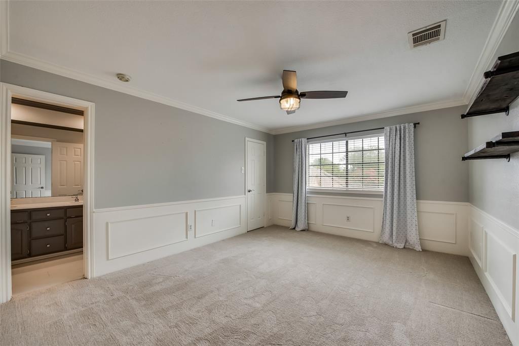 15720 Golden Creek Road Dallas, TX 75248 - Photo 19 of 25 Spacious room featuring light gray walls, white wainscoting, and plush carpeting