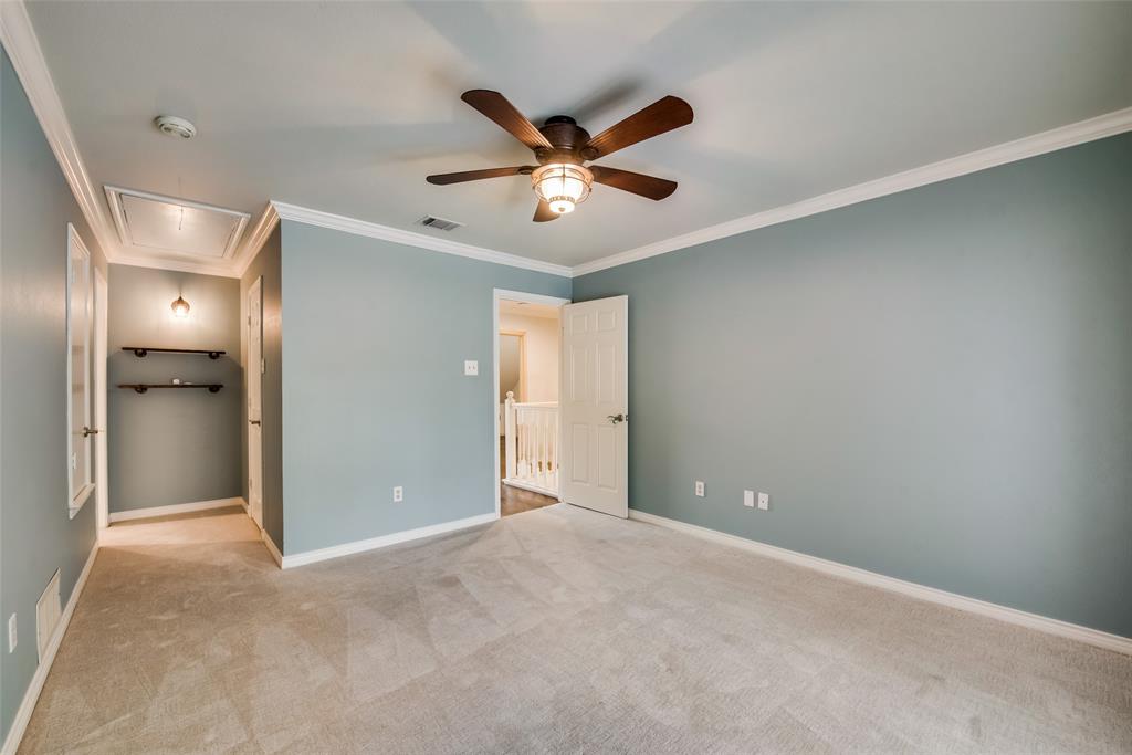 15720 Golden Creek Road Dallas, TX 75248 - Photo 22 of 25 Spacious room featuring light-colored carpet, crown molding, and a ceiling fan with light fixture