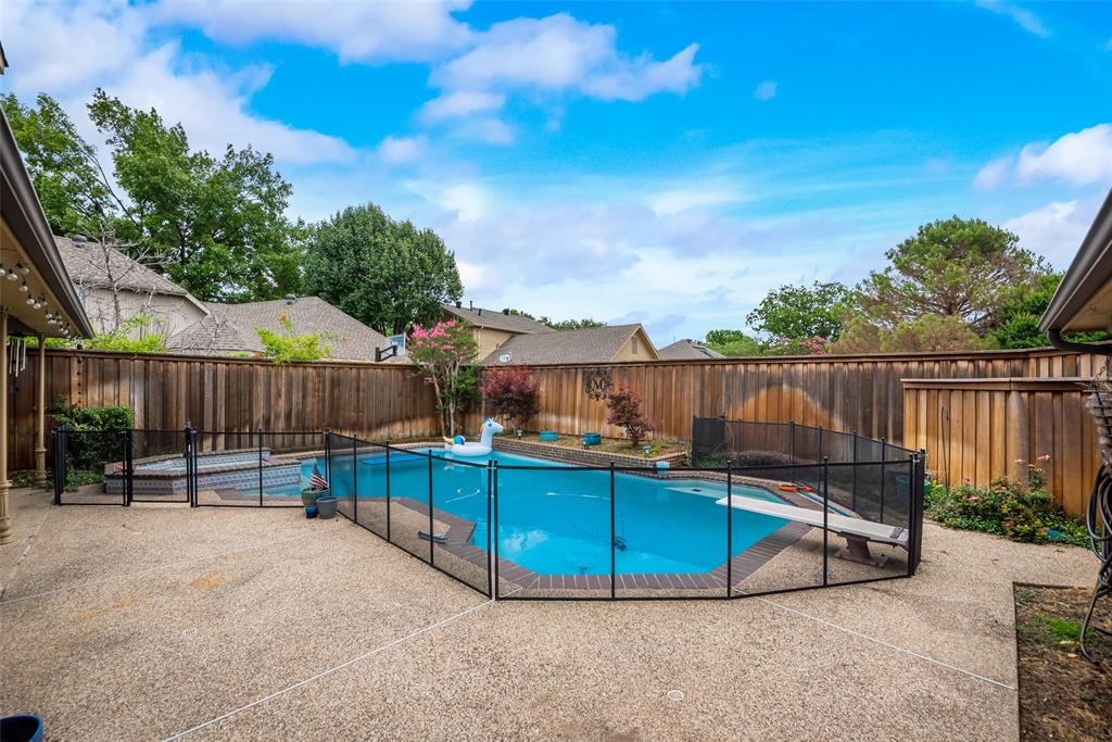 15720 Golden Creek Road Dallas, TX 75248 - Photo 23 of 25 The property features a fenced backyard with a swimming pool and a separate hot tub