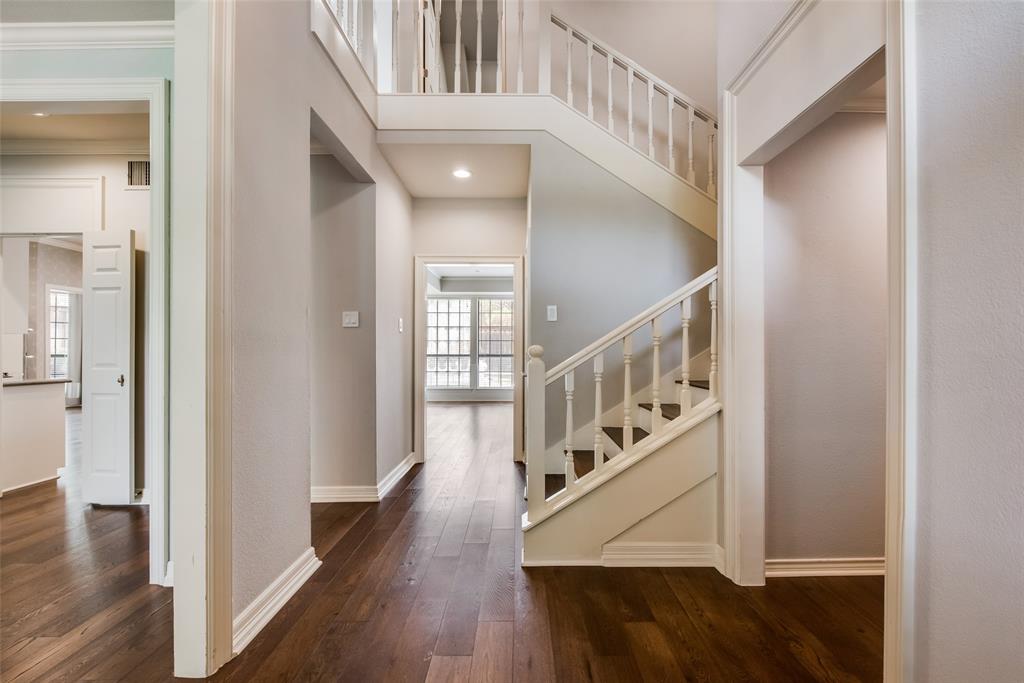 15720 Golden Creek Road Dallas, TX 75248 - Photo 4 of 25 The entryway features rich hardwood flooring, a staircase with white balusters, and recessed lighting