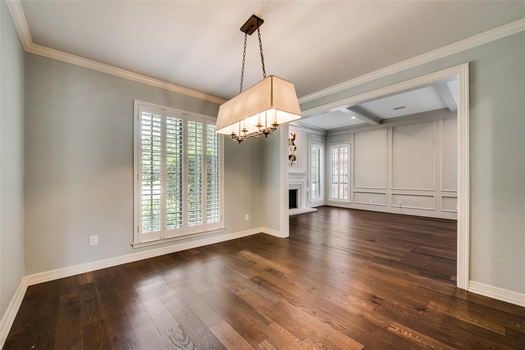 15720 Golden Creek Road Dallas, TX 75248 - Photo 5 of 25 Living space featuring dark hardwood floors, a prominent chandelier, and crown molding