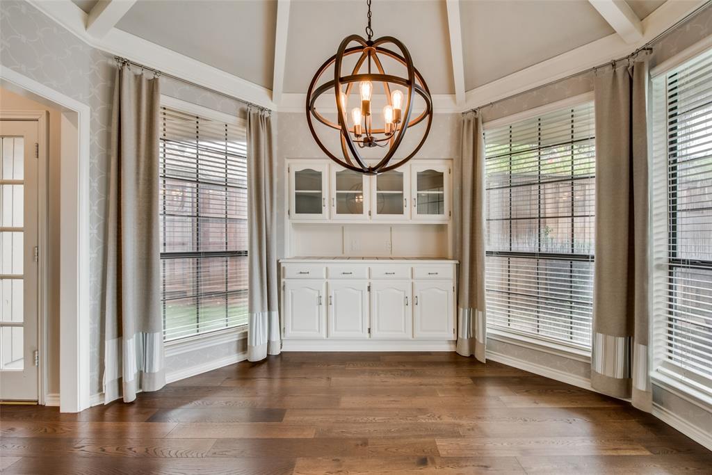 15720 Golden Creek Road Dallas, TX 75248 - Photo 8 of 25 This space features rich hardwood flooring, a unique orb chandelier, and built-in white cabinetry with a countertop