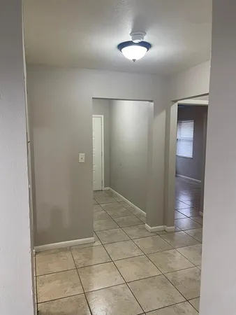 an empty room with closet and chandelier fan