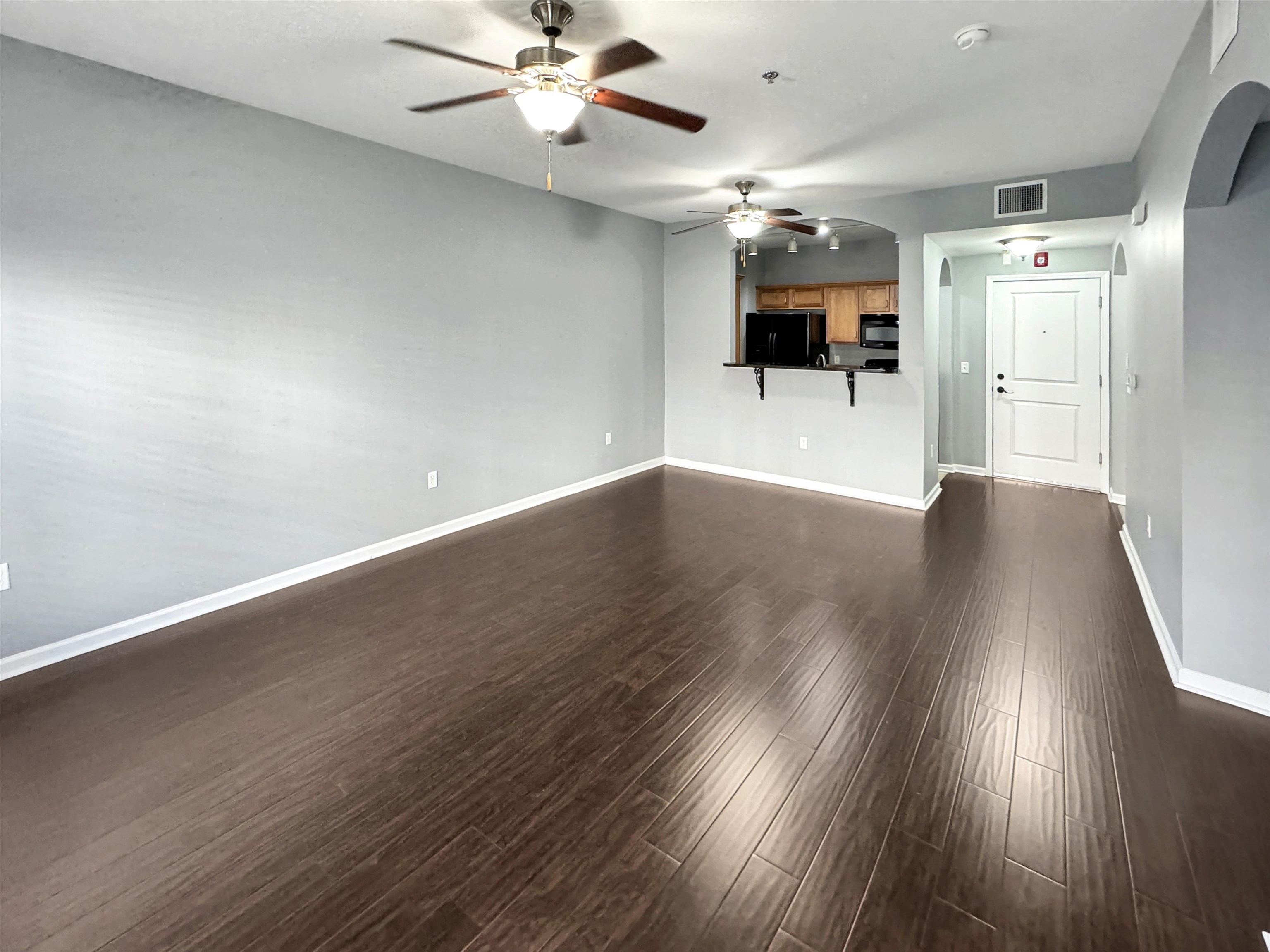 665 Tennessee Street, Unit 306 Memphis, TN 38103 - Photo 11 of 35 an empty room with wooden floor and windows