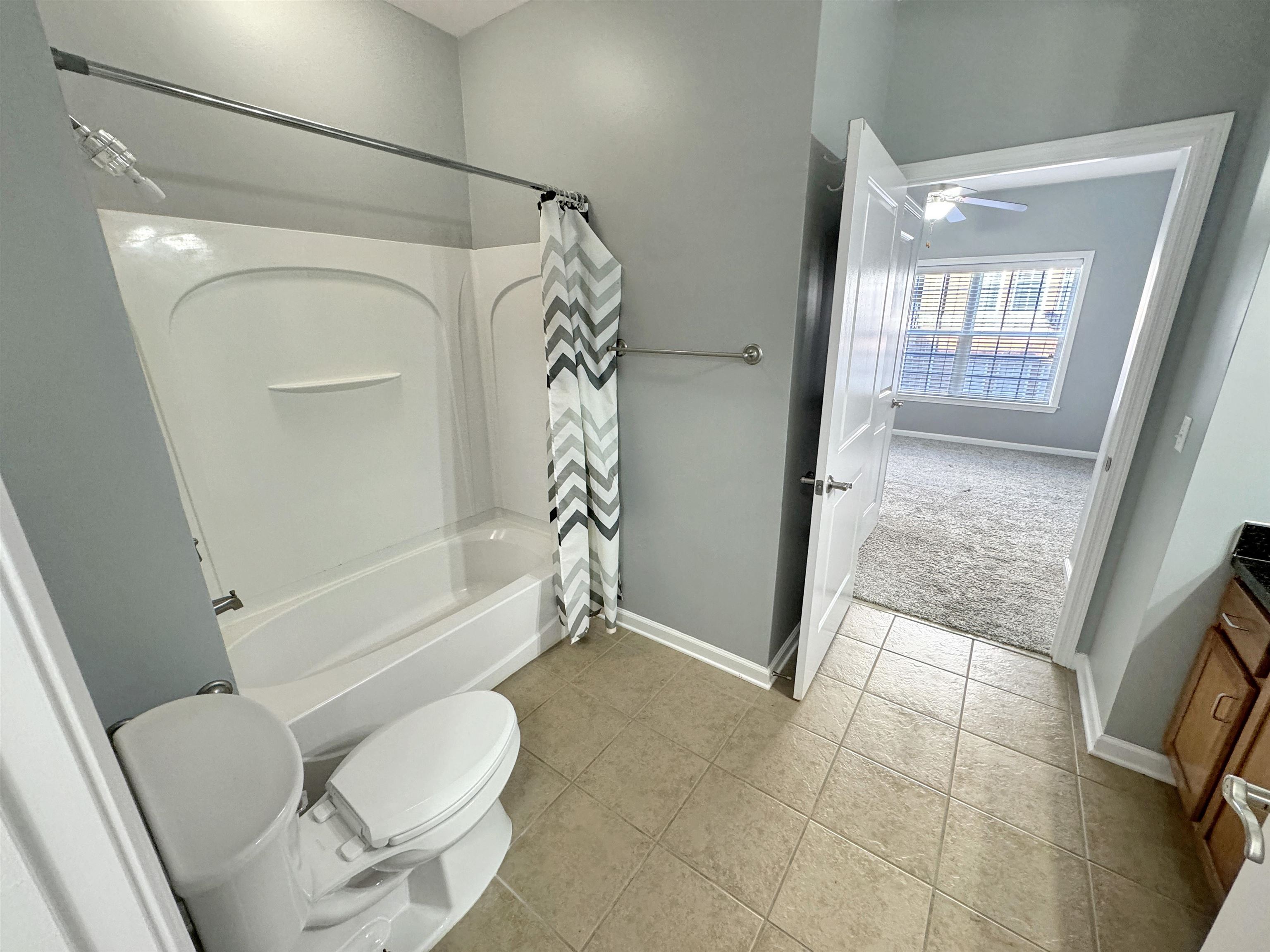 665 Tennessee Street, Unit 306 Memphis, TN 38103 - Photo 17 of 35 a bathroom with a granite countertop bathtub shower and toilet