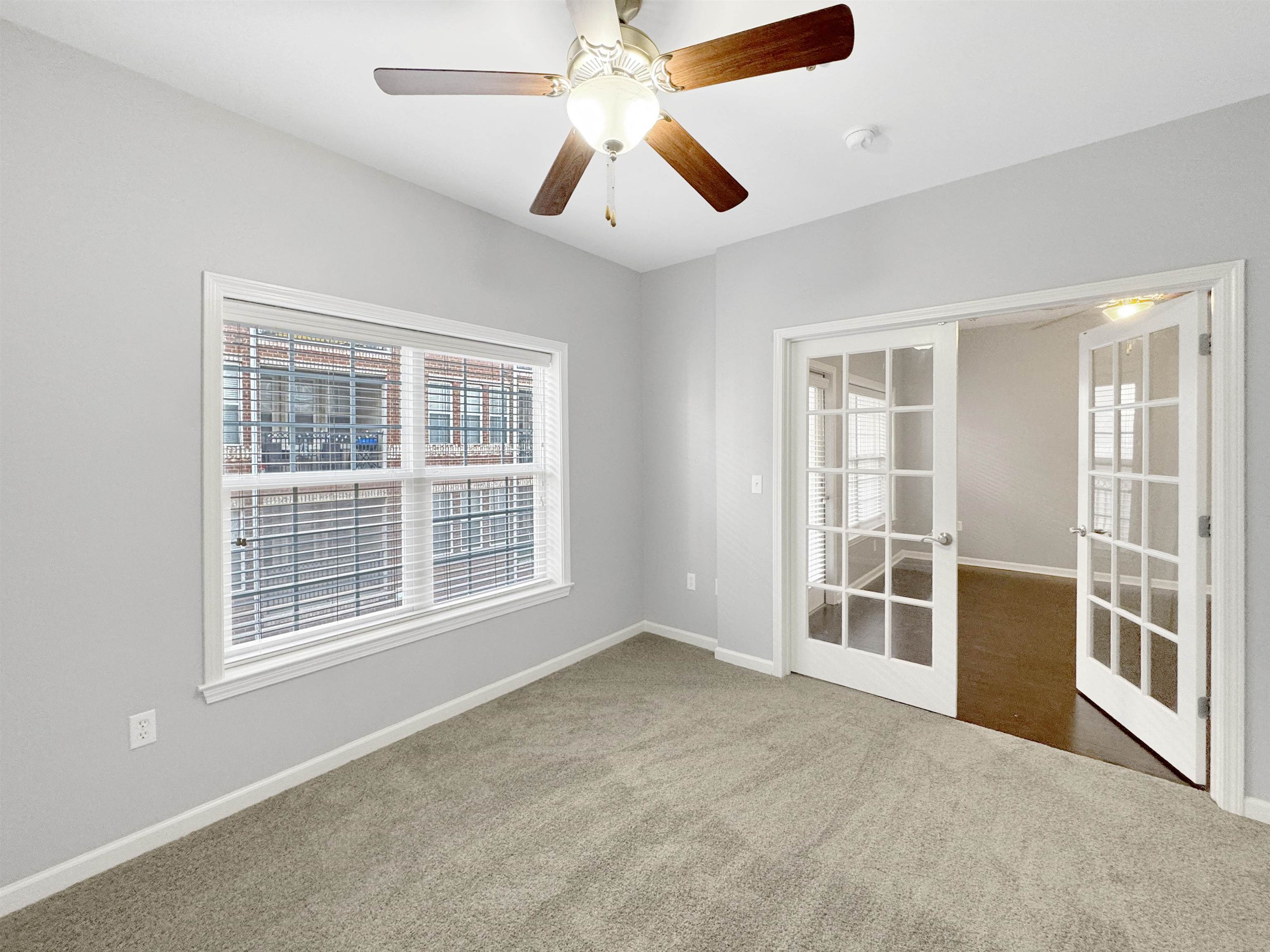 665 Tennessee Street, Unit 306 Memphis, TN 38103 - Photo 20 of 35 an empty room with chandelier fan and windows