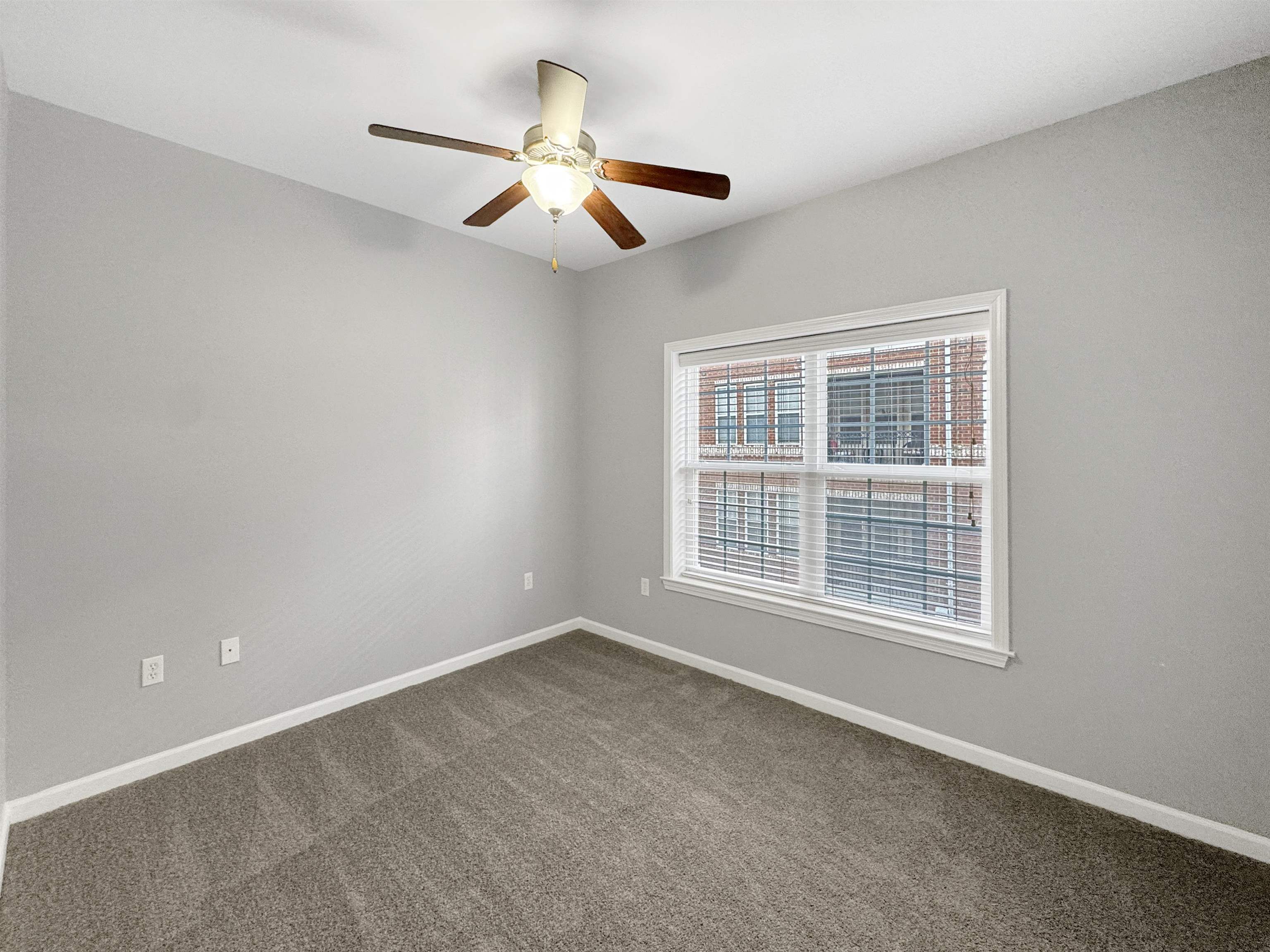 665 Tennessee Street, Unit 306 Memphis, TN 38103 - Photo 21 of 35 a view of an empty room with a window and a ceiling fan