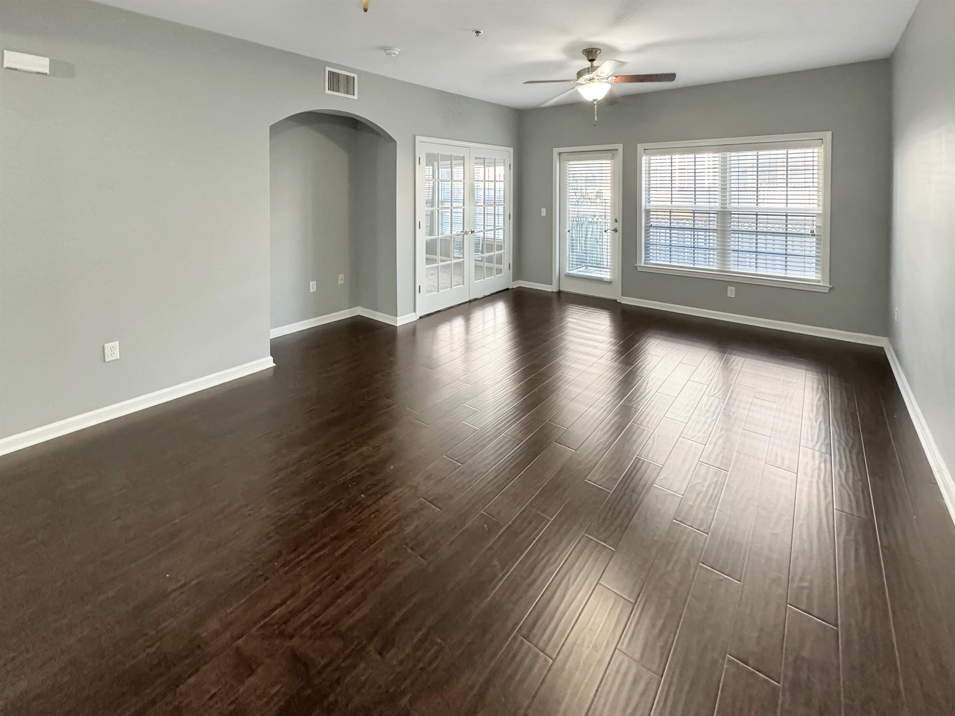 665 Tennessee Street, Unit 306 Memphis, TN 38103 - Photo 6 of 35 an empty room with wooden floor and windows