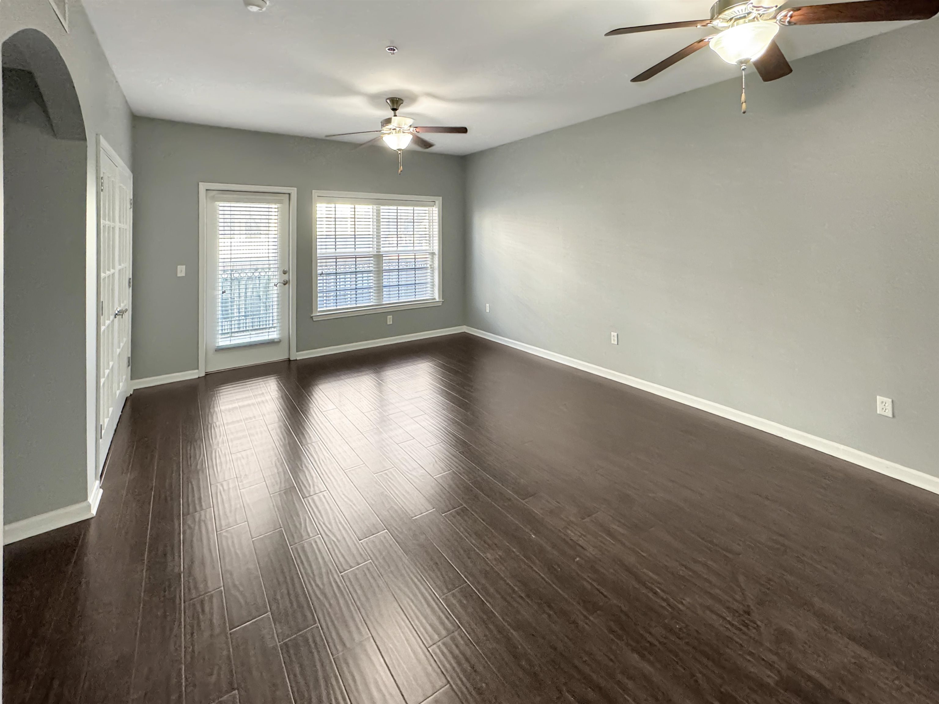 665 Tennessee Street, Unit 306 Memphis, TN 38103 - Photo 7 of 35 an empty room with wooden floor and windows