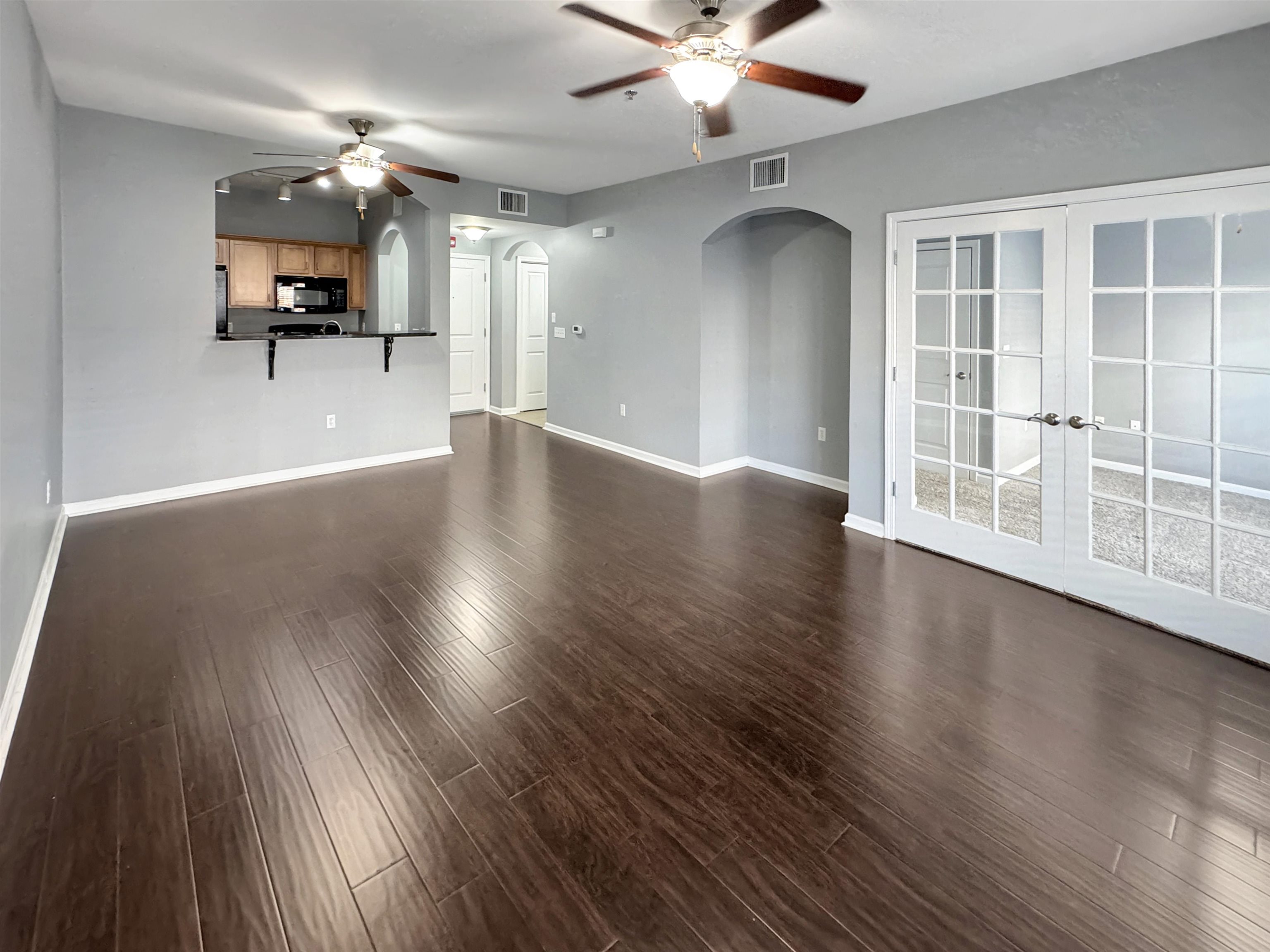 665 Tennessee Street, Unit 306 Memphis, TN 38103 - Photo 8 of 35 a view of an empty room with wooden floor and a window