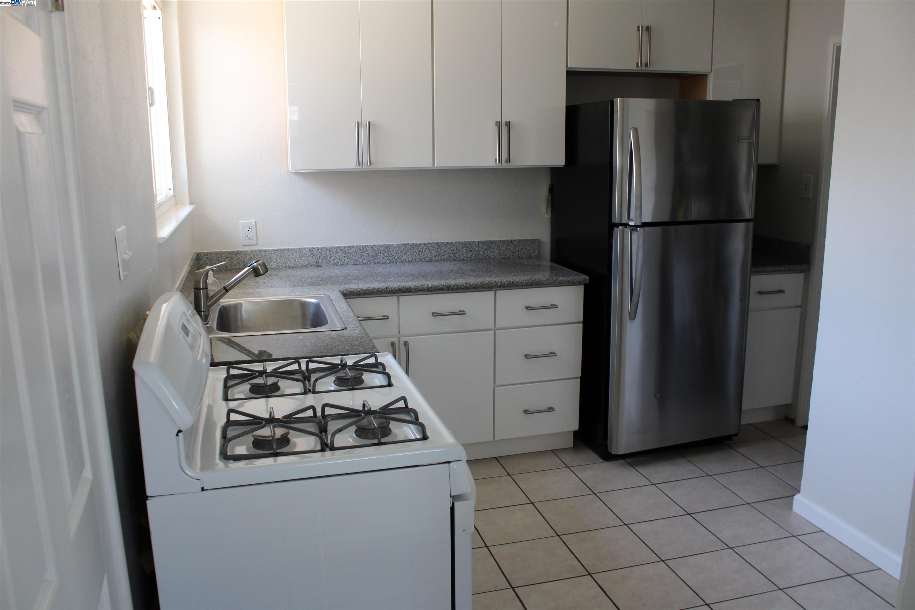 1314 Ashby Avenue Berkeley, CA 94702 - Photo 7 of 8 a kitchen with appliances and cabinets
