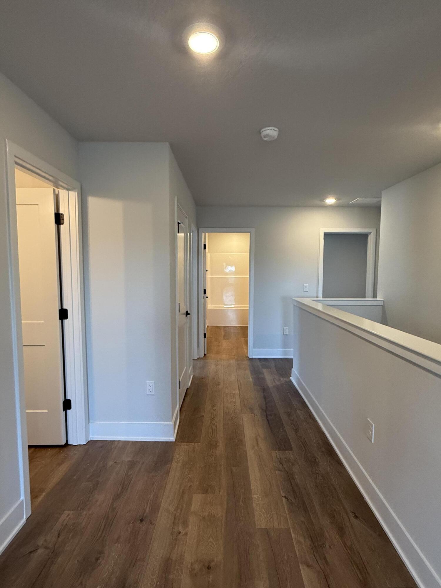 2410 Aleia Lane Crestview, FL 32536 - Photo 11 of 37 a view of a hallway with wooden floor